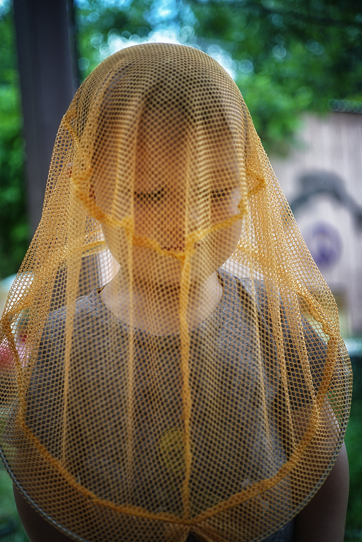 boy with butterfly net over head