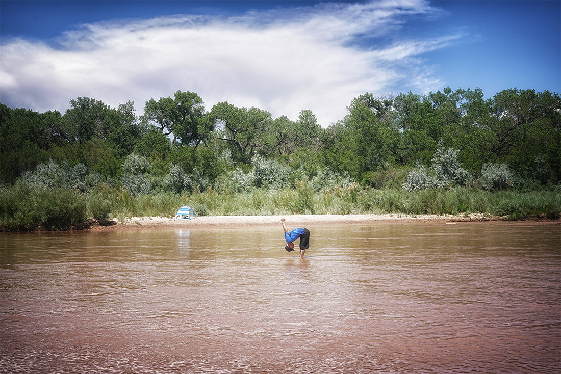 man doing yoga in river